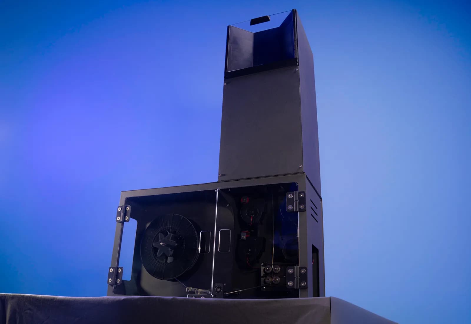 The ASTER-C extrusion and spooling bay open, showing the spool, cooling blowers and drive rollers