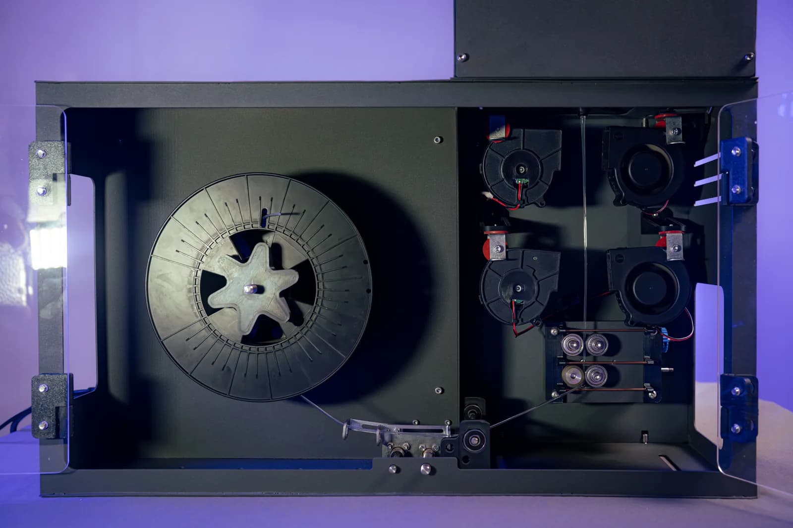 Inside the ASTER-C spooling bay: collet-type spool holder, cooling blowers and the diameter sensing rollers